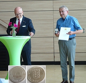 Landrat Norbert Heuser (links) überreicht ÖDP-Kreisrat Klaus Ries-Müller eine Ehrenmedaille für 30 Jahre Tätigkeit im Kreistag